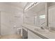 Bathroom featuring white cabinetry, solid surface counter, and large mirror above vanity at 3605 Kingswood Ct, Clermont, FL 34711