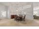 Elegant dining area showcasing a large mirror, stylish chandelier, and neutral carpet at 3605 Kingswood Ct, Clermont, FL 34711