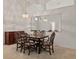 Bright dining room features a large mirror, chandelier, and neutral carpet flooring at 3605 Kingswood Ct, Clermont, FL 34711