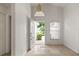 Bright and airy foyer with an open door, neutral-toned tile flooring, and arched transom window at 3605 Kingswood Ct, Clermont, FL 34711