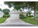 Charming single-story home with a paver driveway, manicured lawn, and mature trees providing ample shade at 3605 Kingswood Ct, Clermont, FL 34711