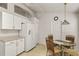 Bright kitchen with white appliances and cabinets, plus a cozy breakfast nook at 3605 Kingswood Ct, Clermont, FL 34711