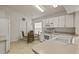Cozy kitchen includes white appliances, ample cabinet space, and a breakfast nook at 3605 Kingswood Ct, Clermont, FL 34711
