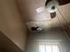 Damaged ceiling with a hole next to a window and fan in a real estate image, needing repair at 3999 Walker Lake Rd, Bartow, FL 33830
