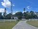 Charming ranch-style home with a long driveway and fenced yard in a rural setting at 3999 Walker Lake Rd, Bartow, FL 33830