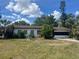 Exterior of a one story home with a front yard and attached garage at 3999 Walker Lake Rd, Bartow, FL 33830