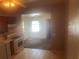 An older style kitchen with view to adjoining rooms at 3999 Walker Lake Rd, Bartow, FL 33830