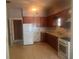 Basic kitchen with white appliances and dark wood cabinets at 3999 Walker Lake Rd, Bartow, FL 33830