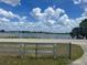 Scenic lake view from across the street with a fence in the foreground at 3999 Walker Lake Rd, Bartow, FL 33830