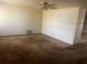 Vacant living room featuring neutral walls, aged carpet and ceiling fan at 3999 Walker Lake Rd, Bartow, FL 33830