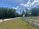 Roadside view with green spaces and a white fence at 3999 Walker Lake Rd, Bartow, FL 33830