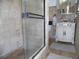 This bathroom has a glass door shower and a vanity with an oval white sink at 40 N Triplet Lake Dr, Casselberry, FL 32707