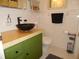 Charming bathroom with unique vessel sink, green vanity, and white tiled walls at 40 N Triplet Lake Dr, Casselberry, FL 32707