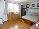 Serene bedroom featuring hardwood floors, and ample natural light, creating a peaceful retreat at 40 N Triplet Lake Dr, Casselberry, FL 32707
