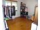 An additional bedroom with hardwood floors, large window, and ample storage racks at 40 N Triplet Lake Dr, Casselberry, FL 32707