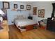 This bedroom features a platform bed, hardwood floors, and colorful art at 40 N Triplet Lake Dr, Casselberry, FL 32707