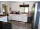 Well-lit kitchen with white cabinets, updated appliances, and a window over the sink for natural light at 40 N Triplet Lake Dr, Casselberry, FL 32707