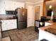 Spacious kitchen with stainless steel refrigerator and appliances, accented by white cabinets and tile floors at 40 N Triplet Lake Dr, Casselberry, FL 32707
