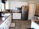 Functional kitchen featuring white cabinetry, stainless steel appliances, and neutral tile flooring at 40 N Triplet Lake Dr, Casselberry, FL 32707