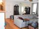 Open living space with hardwood floors flowing into a comfortable seating area, with direct access to the entry door at 40 N Triplet Lake Dr, Casselberry, FL 32707