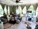 Bright sunroom with tiled floors, multiple windows and green curtains at 40 N Triplet Lake Dr, Casselberry, FL 32707