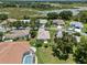Aerial view of a single Gathering home near a pond and green space at 4814 Saint Andrews Arc, Leesburg, FL 34748