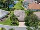 Beautiful single Gathering home with mature landscaping, green lawn and paver driveway at 4814 Saint Andrews Arc, Leesburg, FL 34748