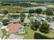 A lovely aerial view shows a neighborhood near a pond and wetlands at 4814 Saint Andrews Arc, Leesburg, FL 34748