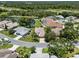 Aerial view of a lovely single Gathering home with mature landscaping near a lake at 4814 Saint Andrews Arc, Leesburg, FL 34748
