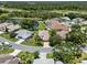Aerial view of a lovely single Gathering home with mature landscaping near a lake at 4814 Saint Andrews Arc, Leesburg, FL 34748