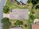 Areal view of single Gathering home with a concrete tile roof and manicured lawn at 4814 Saint Andrews Arc, Leesburg, FL 34748