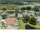 Aerial view of a single Gathering home near a pond and green space at 4814 Saint Andrews Arc, Leesburg, FL 34748