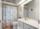 Bright bathroom showcasing a vanity with sink, toilet, a shower with curtains, and ample natural light at 4814 Saint Andrews Arc, Leesburg, FL 34748