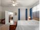 Bedroom featuring a ceiling fan, natural light, and a connecting door to living area at 4814 Saint Andrews Arc, Leesburg, FL 34748