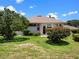 Well-maintained home exterior showcasing a manicured lawn and inviting outdoor space at 4814 Saint Andrews Arc, Leesburg, FL 34748