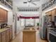 Bright kitchen featuring stainless steel appliances, an island with granite countertops, and eat-in breakfast nook at 4814 Saint Andrews Arc, Leesburg, FL 34748