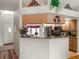 View of the kitchen with stainless appliances, marble countertops, breakfast bar, and a view into the entryway at 4814 Saint Andrews Arc, Leesburg, FL 34748