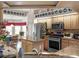 Cozy kitchen showcasing stainless steel appliances, an island with granite countertops, and eat-in dining area at 4814 Saint Andrews Arc, Leesburg, FL 34748