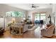 Bright living room featuring an arch window, wood floors, and an open layout at 4814 Saint Andrews Arc, Leesburg, FL 34748