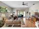 Bright living room featuring an arch window, wood floors, and an open layout at 4814 Saint Andrews Arc, Leesburg, FL 34748