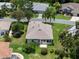 Aerial view of rear exterior, showing roof, patio, mature landscaping and green lawn at 4814 Saint Andrews Arc, Leesburg, FL 34748