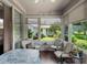 Charming sunroom with lots of natural light offering a view of the yard and community at 4814 Saint Andrews Arc, Leesburg, FL 34748