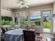 Inviting sunroom with views, natural light, outdoor access, and an elegant table setting at 4814 Saint Andrews Arc, Leesburg, FL 34748