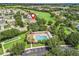 Aerial view showcasing the community pool, clubhouse, and residential neighborhood at 487 Thistledown Way, The Villages, FL 32162