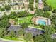 Aerial view showcasing the community pool, clubhouse, and parking area at 487 Thistledown Way, The Villages, FL 32162