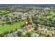 Beautiful aerial view of the home with lush green golf course and vibrant landscaping at 487 Thistledown Way, The Villages, FL 32162
