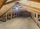 Spacious attic storage space with wooden beams and plank flooring at 487 Thistledown Way, The Villages, FL 32162