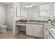 Bathroom with white cabinetry, granite countertops, and plenty of counter space at 487 Thistledown Way, The Villages, FL 32162