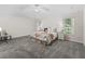 Spacious bedroom featuring plush carpeting, neutral colors, and natural light from the windows at 487 Thistledown Way, The Villages, FL 32162