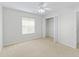 Neutral bedroom with a closet and large window provides ample natural light at 487 Thistledown Way, The Villages, FL 32162